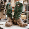 Photo of boots in need of restoration and repair on a work bench